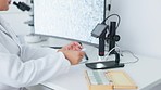 Laboratory scientist examining monkeypox virus on computer and using microscope glass slide. Biochemist engineer searching for breakthrough cure in medical research and writing discovery on clipboard