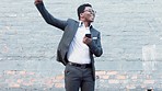 Celebrating business man cheering his promotion, success or achievement after reading a message on his phone while outside in the city. Cheerful young corporate professional overjoyed with good news