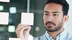 A happy businessman writing ideas on a transparent board. Inspired corporate professional brainstorming solutions and strategy for a new project. Manager thinking or planning on a clear whiteboard 