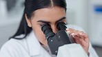 Scientist looks in a microscope to examine monkeypox sample in a research laboratory. Biochemist engineer searching for breakthrough virus cure through medical analysis and trying to discover a cure