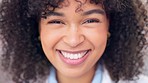 Happy female pharmacist smiling and looking cheerful. Closeup face of joyful african medical worker with afro standing inside. Head portrait of a friendly and cute chemist working in a pharmacy