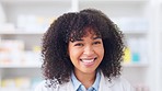 Face of a friendly pharmacist working in a pharmacy. Happy African woman with afro smiling and looking confident while working in a drugstore. Woman enjoying her career in the healthcare industry