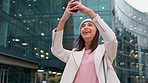 Trendy woman taking picture of big urban city buildings on her phone while out exploring and sightseeing in a town. Female tourist capturing sights and views for social media while traveling