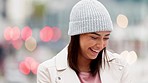 POV portrait of a camera shy girl outside in an urban city. Youthful woman with playful expression hiding her face looking embarrassed and laughing. Cute introverted female enjoying her time outdoors