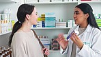 Talking pharmacist explaining medication to patient in clinic pharmacy, sharing trusted knowledge or selling drug recommendation. Medical professional helping or showing customer prescription dosage