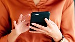 Journalist reading social media news on a phone inside an office. Closeup of hands of a female reporter scrolling on the internet for trending stories. A newswoman browsing the web