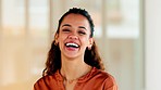 Latino business woman smiling and laughing with joy in an office. Portrait of a confident and ambitious young entrepreneur feeling motivated, empowered and optimistic for success in a startup company