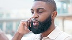 Angry man talking on a phone call receiving bad service. Stressed black businessman yelling at work colleagues. Unhappy African American male customer having a conversation with a corporate manager.