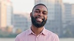 Face of a happy business man smiling while standing outside in the city. Confident african american corporate professional showing perfect teeth after good oral and dental care or hygiene routine