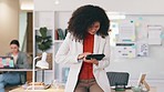 Happy, smiling and laughing black business woman browsing on a digital tablet in a modern office. Portrait of confident entrepreneur feeling ambitious and motivated for success while planning online