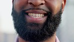 An optimistic young man with a bright smile standing outdoors. The face of a friendly bearded male student smiling outside in an urban town. A hopeful and happy volunteer satisfied with his work