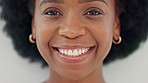 Face of an african american woman smiling and laughing with joy at the camera. Portrait of a cheerful, cool and confident female with afro hair and a positive attitude feeling excited in a good mood