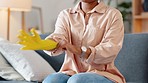 A cleaner putting on gloves, getting ready to do chores and housework. Closeup of a woman putting cleaning mitts on her hands, preparing to spring clean and keep her home neat, tidy and hygienic 