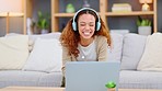 Au pair using laptop and headphones for video call to connect and communicate with family and friends during lockdown. Smiling young woman talking and laughing while hosting online chat on technology