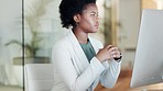 Serious black business woman looking focused, thinking and working on computer in a modern office. Confident young professional feeling determined and motivated for success in a corporate company