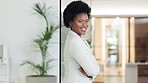 Black business woman smiling and laughing while standing with arms crossed in an office. Confident, happy and empowered female entepreneur with afro hair feeling motivated and ambitious for success
