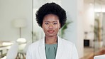 Confident, laughing chartered accountant with afro showing friendly facial expression or trust and looking forward in accounting firm. Portrait of professional advisor ready to help or assist clients