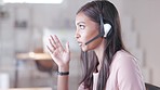 Talking call centre agent wearing headset in office and promoting or marketing deals and sales to clients. Assertive and confident customer service operator helping, explaining and advising customers