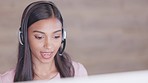 Friendly call center agent using headset while consulting for customer service and sales support. Confident young assistant talking to clients to explain offers and promotions while selling products