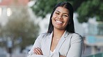 Corporate worker looking confident with her teeth whitening result. Face of a young and proud business woman with a big smile expression and arms crossed standing outside in a park or city garden