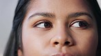 Closeup of a DIY electrician with brown eyes searching for electrical issue or short circuit for repair inside home or office building. Detail face of a woman looking curious and thinking of solution