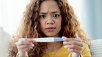 Woman receives shocking news from pregnancy test. Isolate young lady is disappointed to see that the results are positive. Stressed and concerned, she is in a state of confusion as what to do next.