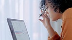 Closeup of a serious businness woman or student studying graphs and charts on a laptop screen. Freelance entrepreneur analyzing online statistics while thinking of  solution ideas to improve sales