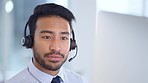 Call center agent talking and listening to a client on a headset while working in an office. Confident and reassuring salesman consulting and operating a helpdesk for customer service and support
