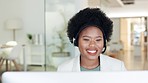 African call centre agent talking on a headset while working in an office. Confident and happy businesswoman with afro hair consulting and operating a helpdesk for customer sales and service support