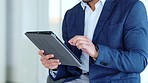 Closeup businessman hands using digital tablet. Formal guy checking the online stock market, trading, buying and selling Male manager browsing internet checking trends in the market. 