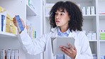 Black pharmacist doing inventory on a digital tablet. African American chemist ordering medication at a modern drugstore. Health care professional ready to assist at a clinic dispensary