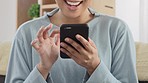 Hands of excited woman touching phone to browse the internet and check messages on social media app. Closeup of female sitting at home laughing at funny videos or feeling happy while shopping online 