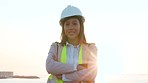 Young professional female worker on construction site. Closeup of happy and confident, independent contractor ready to get the building job done. Woman prepared for the day near coast during sunrise.