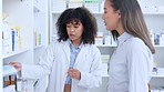 Healthcare worker offering good service and expert advice to customer by recommending and dispensing medicine from a shelf. Friendly pharmacist explaining dosage instructions to woman in a drugstore