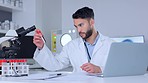 Biologist working with blood collection tubes data and typing information on a laptop. One young male chemist, scientist or healthcare professional doing lab report testing and analyzing samples