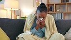 Sick woman suffering from covid fatigue while sitting on a couch at home. Unwell female taking the day off to recover from a bad flu. Lady experiencing chills and shivers from a cold or allergies