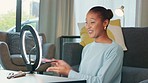 Female vlogger recording a makeup tutorial with phone and LED ring light. Social media influencer testing eyeshadow cosmetics swatch on a live streaming video. Beauty artist showing product online