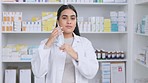 Happy pharmacist removing her surgical face mask at the end of coronavirus pandemic. Excited, relieved chemist or medical worker looking confident in a pharmacy retail store after getting vaccinated