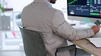 A young business professional looking at the stock market on his computer in a modern office. Closeup of a finance manager adding his card information online. Smart worker working with trading data. 