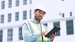 Thinking architect browsing digital tablet, analysing building plans for city planning, residential or office development. Architectural engineer or contractor checking online blueprint on technology