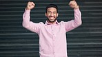 Cheerful, excited and lucky man celebrating success, winning and victory. Portrait of happy, positive and motivated guy cheering with fists at amazing, awesome and surprising good news about a bonus