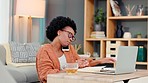 Entrepreneur, freelance and remote worker talking on a phone, typing on a laptop and looking over paperwork. One black female freelancer working from home and discussing business while busy on a call