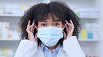 Portrait of happy woman removing mask at the end of covid19. Black health care professional smiling, feeling positive, ready to help, treat and assist with prescriptions and medication at drug store