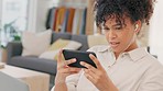 Confused, shocked and surprised woman with phone streaming, watching and enjoying a home movie on online subscription channel. Relaxed woman listening on earphones and playing an action or scary game