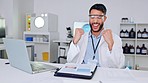 Success, innovation and modern science, health care professional celebrate success reading on a laptop in research room. Young male scientist expressing joy while discovery of a breakthrough or cure