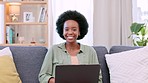 Happy, casual and beautiful female laughing at a joke while working on her social media blog post relaxing at home. Portrait of young, edgy and afro woman, blogger and freelancer typing on her laptop