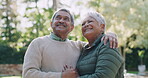 Happy, smiling and mature couple in retirement, bonding and enjoying the outdoors and relaxing together in nature. Romantic, loving and mature husband and wife in love and hugging in summer outside