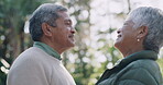 Romantic senior couple kissing on the lips outdoors showing their happiness, romance and a loving old relationship together. Happy, in love and mature husband and wife smiling and enjoying nature