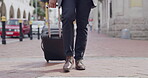 Travel, carry on suit and feet walking in a city, man making his way to meeting in town. Closeup of a formal tourist traveling for business, enjoying a walk downtown before an appointment