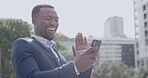 Excited black business man laughing on video call on phone using social media, waving hand and saying goodbye. Positive, happy African American male on facetime while on break, outdoors in the city.